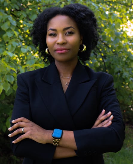 Rachael Twumasi-Corson standing outside in front of a tree with her arms folded