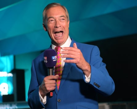 Nigel Farage speaks to the media during the Reform party's annual conference at the National Exhibition Centre in Birmingham on Friday