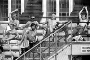Spectators soak up the sun while watching Surrey play Lancashire at The Oval.