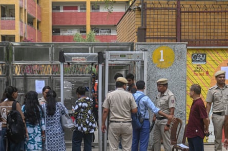 Students being frisked before passing through metal detectors