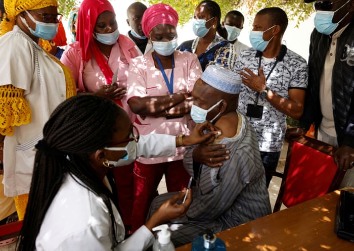 A health worker receives a dose of thev accine in Dakar.