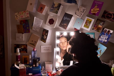 Indira Varma applies makeup in front of a mirror