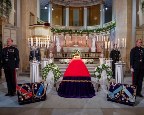 Cadets of the Military Academy stand guard next to the casket of King Harald V of Norway draped with the Royal Flag at the Royal Palace Chapel in Oslo.