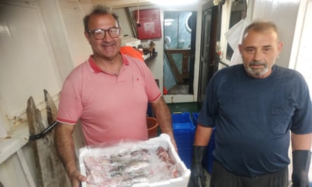 Alessandro Ciavaglia holding a tub of fish packed in ice