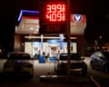 Valero gas station in Hoboken displaying fuel prices at night