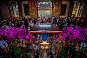 People offer food and pray inside a temple during the celebration of the Chinese lunar new year