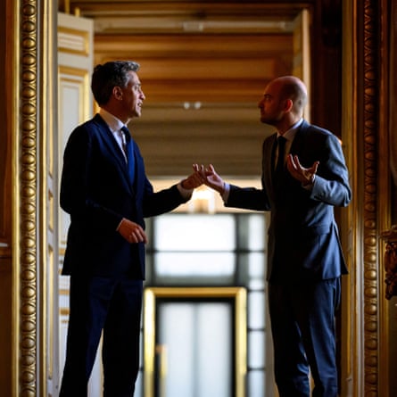 Ed Miliband and Jean-Noël Barrot talk animatedly in a corridor at the Quai d’Orsay
