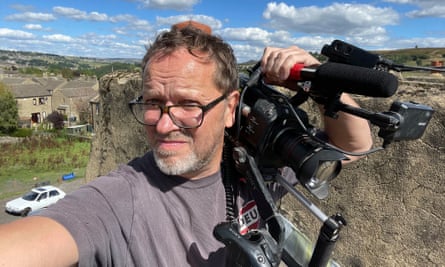 Jeremy Rodway in a field holding a camera