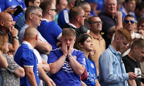 Leicester fans look on anxiously as they hope to hear news of a Bournemouth goal at Goodison Park.