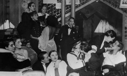 A group of patrons, many dressed as men in tuxedos, at Le Monocle, a famous night club for women in Paris.