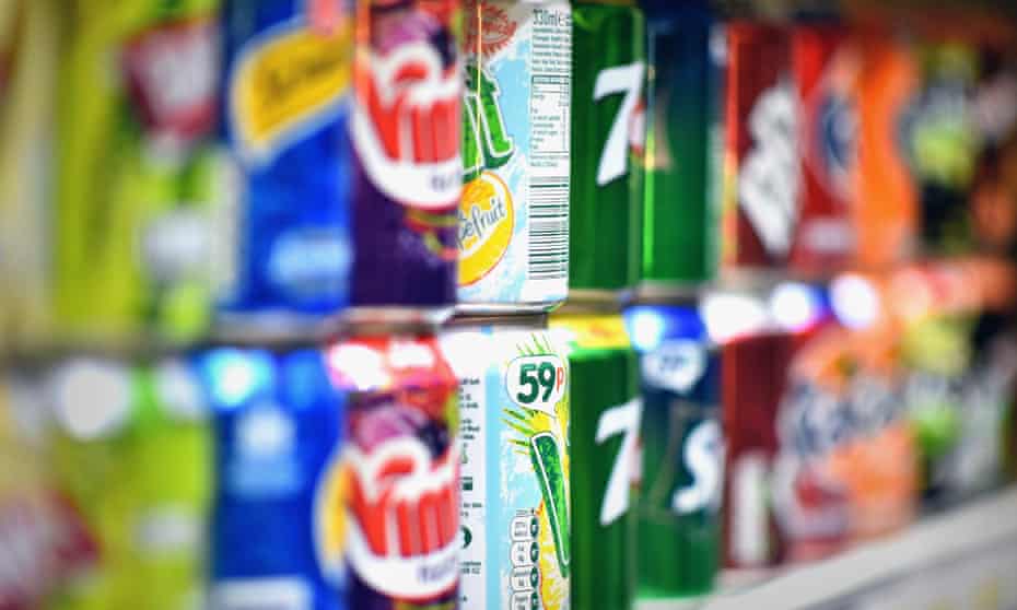 Fizzy drinks cans on a shelf.