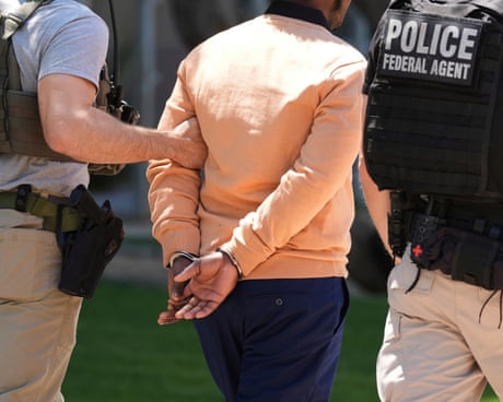 law enforcement officer walk with a detained person