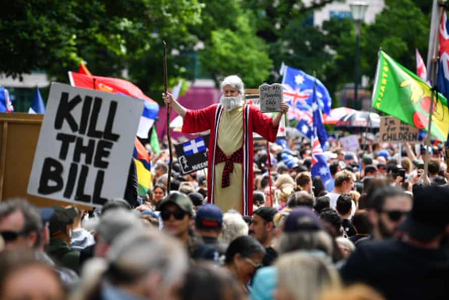 A person dressed as Moses stands over the crowd during ‘The Worldwide Rally for Freedom’ protest against mandatory vaccinations and lockdown measures in Melbourne