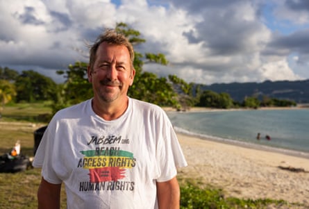 Paul Roberts, Jabbem coordinator, smiles on a beach wearing a beach access rights T-shirt
