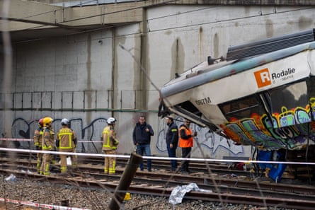 Emergency responders work at the site of the train derailment accident in Gelida