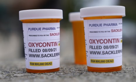 Fake pill bottles with messages about Purdue Pharma are displayed during a protest outside a courthouse in White Plains, New York, on 9 August. 