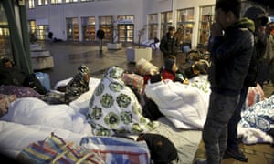 Refugees sleep outside the entrance of the Swedish migration agency’s arrival centre for asylum seekers in Malmo