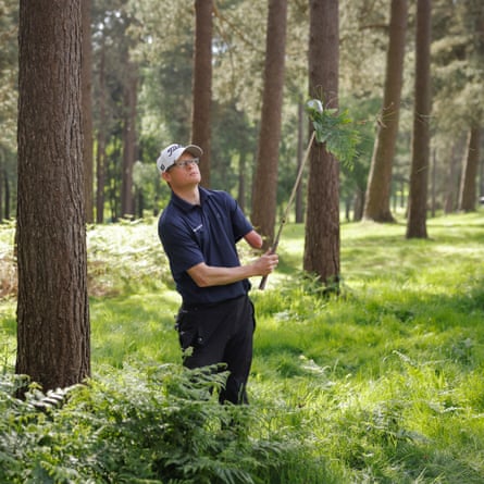 Darren Grey, a 39-year-old golfer with one arm from Cleveland, who is a PGA trainee professional and twice a winner of “the one-armed World Championship”, hacks out of the ferns near the 14th green