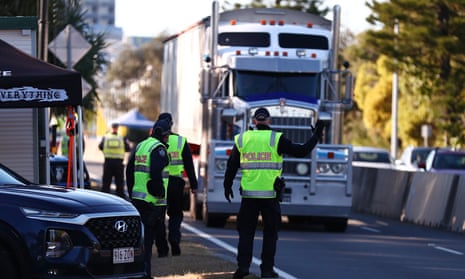 Queensland police stop trucks at the border in Coolangatta on Wednesday. The Queensland government has further tightened border restrictions for people travelling into the state from NSW.