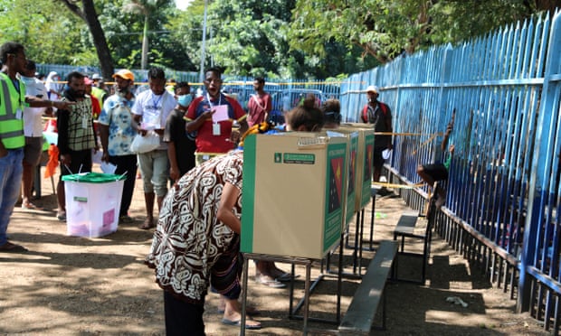 Voters cast their votes at a polling station in the general elections in Papua New Guinea's capital city Port Moresby.