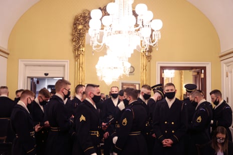 Members of the military stand around prior to a dress rehearsal for the inauguration.