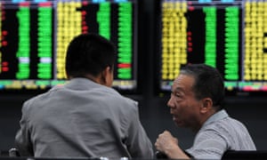 Investors monitor stock prices in a securities company in Jiujiang, China's central Jiangxi province.