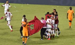 Morocco’s players celebrate after their win in Abidjan sent them to the World Cup at the expense of Ivory Coast.