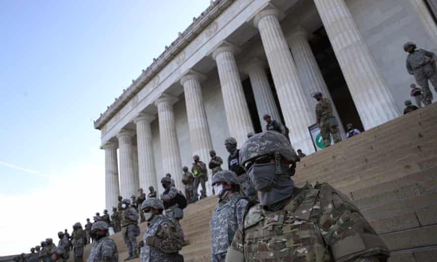 Members of the DC National Guard stand on the steps of the Lincoln Memorial as demonstrators participate in a peaceful protest against police brutality and the death of George Floyd.