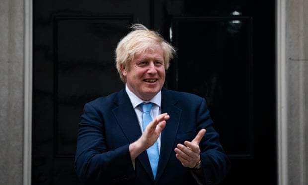 Boris Johnson stands in Downing Street, London, during the nationwide Clap for Carers to recognise and support NHS workers and carers fighting the coronavirus pandemic, May 21, 2020
