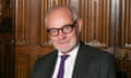 Crispin Blunt at the House of Commons on 26 October 2023: he is seen against a backdrop of dark wooden panelling and wears a dark jacket, white shirt and dark red and blue tie. He has a close-cropped grey beard and short, receding grey hair, and wears dark-rimmed glasses.
