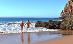A naked couple walk into the sea