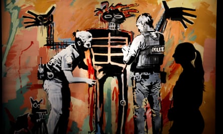 A gallery-goer in front of Banksy’s Basquiat Being Stop and Searched (2017) at the GoMA show.