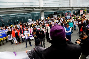people hold signs in an airport