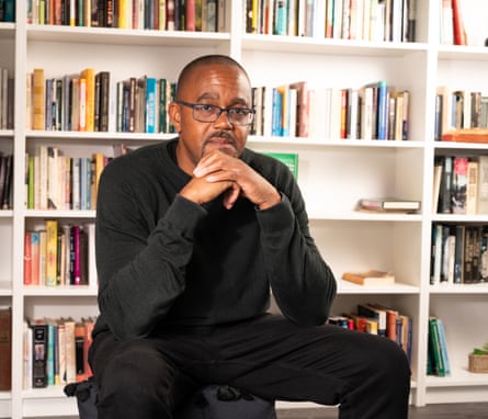 Kehinde Andrews sat in front of a bookcase