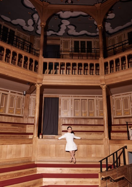 Francesca Mills in a white dress poses at the Sam Wanamaker Playhouse