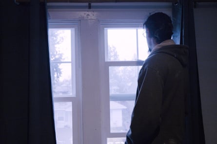 a man looks out a window