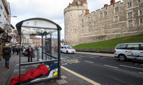 A person sleeps rough in a bus shelter outside Windsor Castle earlier this month. 