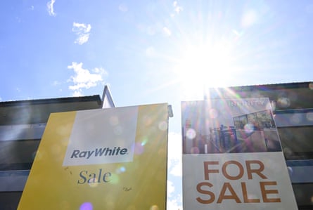 ‘For Sale’ signs in front of apartment blocks