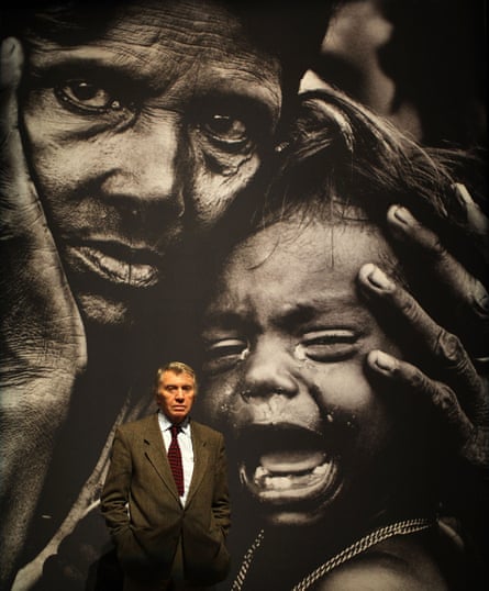 Don McCullin poses next to ‘A woman and child waiting for medical attention’ taken by him in Bangladesh in 1971.
