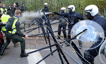 Police spray tear gas during clashes with protesters in Belgium.
