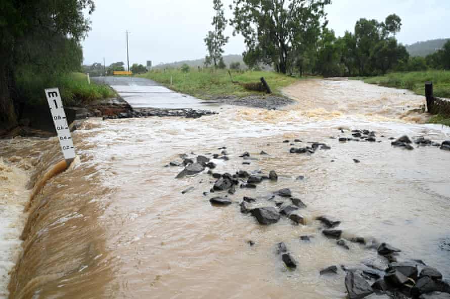 A road is cut by floodwater near Laidley.