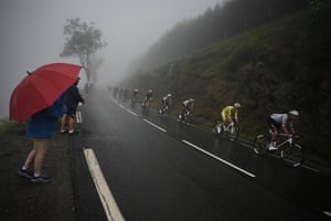 Tadej Pogacar, wearing the overall leader’s yellow jersey, second right, follows UAE Team Emirates teammate Marc Soler during the 14th stage