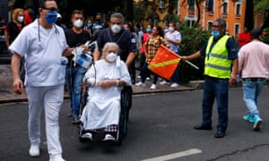 A woman is evacuated with the help of medical staff from the Obregón hospital in Mexico City