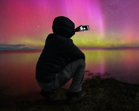 A photographer captures the aurora australis – or southern lights – glowing on the horizon over Lake Ellesmere in New Zealand.