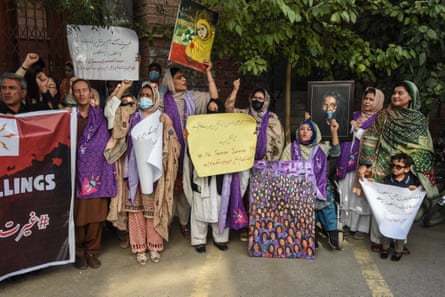 A crown of protesters holding banners.