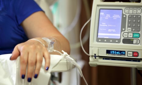 Infusion pump feeding IV drip into patient's arm