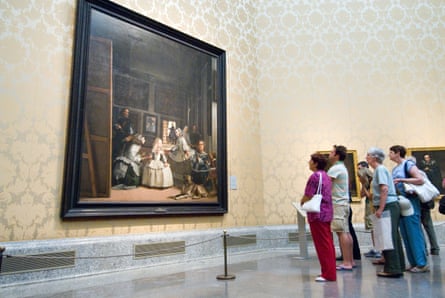 Large painting to left with small group of people viewing to right in gallery
