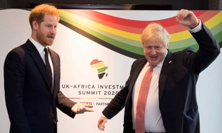 Boris Johnson punches the air while Prince Harry points in his direction