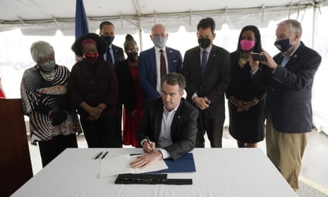 The Virginia governor, Ralph Northam, signs a bill abolishing the death penalty surrounded by legislators and activists at Greensville correctional center.