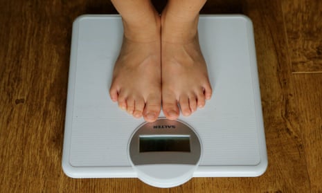 A child being weighed on scales.